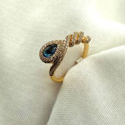 18 kt rosé gouden slangen ring met donker blauwe topaas